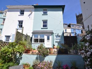 a white house with potted plants in front of it at 1 bed in Brixham BX046 in Brixham
