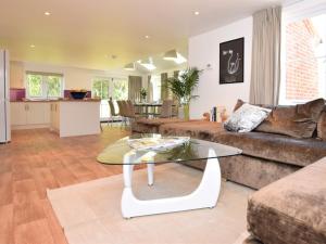 a living room with a couch and a glass table at 5 Bed in Wroxham 56103 in Hoveton