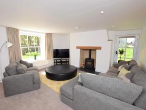 a living room with two couches and a fire place at 5 Bed in Wroxham 56103 in Hoveton