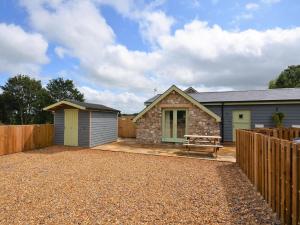 a house with a bench and a fence at 2 Bed in Croes-y-pant 58961 in Mamhilad