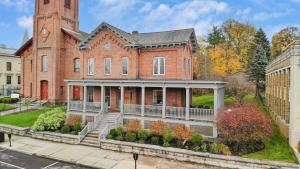 a large red brick house with a tower at Beatrice by AvantStay Charming Catskills Escape in Catskill