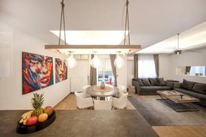 a living room with a couch and a table at GLAMOROUS APARTMENT IN KOLONAKI CENTER in Athens