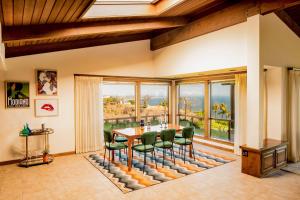 a dining room with a table and chairs and a large window at Cliffridge by AvantStay Lush Malibu Hills Estate w Breathtaking Ocean Views in Malibu