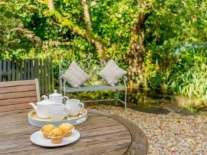 a table with cups and muffins on top of it at 3 Bed in Cartmel 66725 in Holker