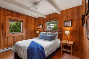 una camera con pareti in legno e un letto in una stanza di The Pilot House by AvantStay Stunning Home Right On Arch Cape Beach ad Arch Cape
