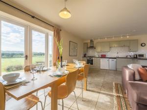 a dining room and kitchen with a table and chairs at 2 bed in Pensthorpe KT188 in Kettlestone