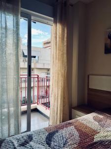 a bedroom with a bed and a window with a balcony at Nice and new furnished apartments in Torrevieja centre in Torrevieja