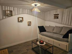 a living room with a couch and a table at Appartement rénové proche gares d'Orléans et Fleury les aubrais in Orléans