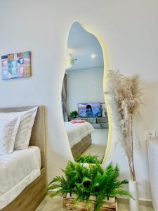 a living room with a mirror and a bed at The Song Vung Tau Near Beach by Hoang Gia in Vung Tau