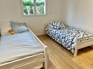 une petite chambre avec un lit et une fenêtre dans l'établissement Maison avec piscine et jardin privatifs - un séjour au calme, à Biscarrosse