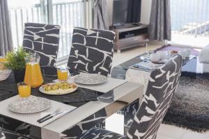 a dining room table with plates of food and orange juice at Apartamento Bellavista Puerto 3 in Cala Ratjada