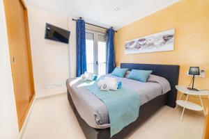 a bedroom with a bed with two teddy bears on it at Apartamento Bellavista Puerto 3 in Cala Ratjada