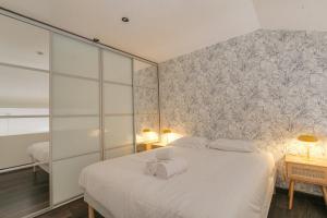 una camera da letto con un letto e due asciugamani di Duplex spacieux et design proche la Part-Dieu a Lione