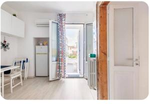 an open door to a kitchen with a refrigerator at Casa dei nonni in Capurso