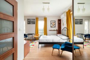 a bedroom with a bed and a dining room at Warszawa Gocławek Comfort Studio in Warsaw