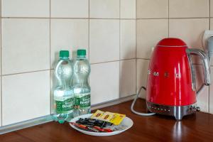 a counter with two bottles of water and a toaster at Warszawa Gocławek Comfort Studio in Warsaw