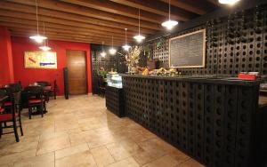 a restaurant with a bar and tables and chairs at TERRE PETRUSSA in Cividale del Friuli