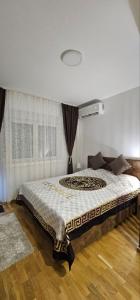 ein Schlafzimmer mit einem großen Bett vor einem Fenster in der Unterkunft Dia in Vrnjačka Banja