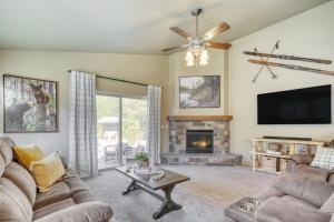 a living room with a fireplace and a tv at Black Bear Cabin by AvantStay Modern Bend Escape in Bend