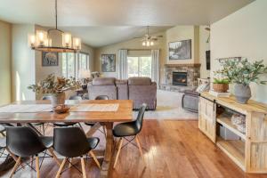 a kitchen and living room with a wooden table and chairs at Black Bear Cabin by AvantStay Modern Bend Escape in Bend