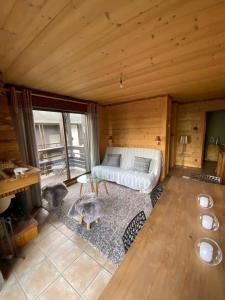 a bedroom with a bed in a wooden cabin at Apartment with balcony and panoramic view between sky and mountains in Megève
