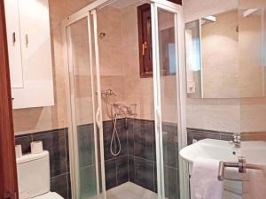 a bathroom with a shower and a toilet and a sink at Apartamentos Sallent de Gállego 3000 in Sallent de Gállego +20 photos
