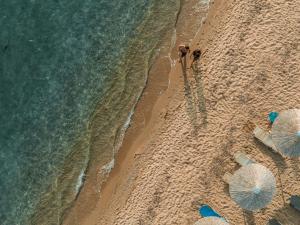 an overhead view of a beach with two people and the ocean at Secret Paradise Hotel & Spa in Nea Kallikrateia +42 photos