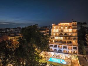 a large building with lights on it at night at Secret Paradise Hotel & Spa in Nea Kallikrateia