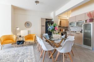 a kitchen and dining room with a table and chairs at Zephyrus Cityscape Condo,By IdealStay Experience in Heraklio