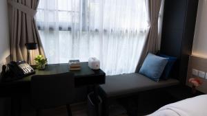 a bedroom with a desk and a window at VicHaus Serviced Apartment in Singapore