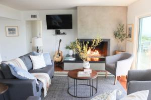 a living room with a couch and a fireplace at Bluff by AvantStay Gorgeous Malibu Getaway w Hot Tub Spectacular Ocean Views in Malibu