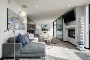 a living room with a couch and a tv at Matador by AvantStay Ocean Front Malibu Pad w Rooftop Patio in Topanga