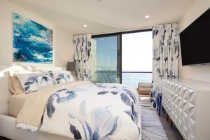 a bedroom with a bed and a large window at Matador by AvantStay Ocean Front Malibu Pad w Rooftop Patio in Topanga