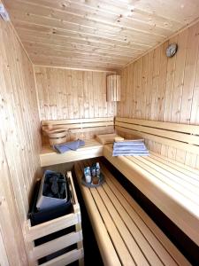 a small wooden sauna with a bench in it at Ferienhaus Diemelblick 39 in Heringhausen