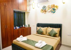 a bedroom with a bed with towels on it at Hotel Urban Sleep Airport Zone in Shamshabad