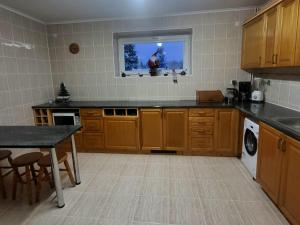 a kitchen with wooden cabinets and a table and a window at SIEDLISKO HARENDA BIESZCZADY in Czarna +41 photos