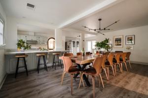 a kitchen and dining room with a wooden table and chairs at Estrella by AvantStay Secluded Spanish-Style Estate on 7 Acres of Vineyards in Windsor