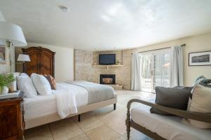 a bedroom with a bed and a fireplace at Estrella by AvantStay Secluded Spanish-Style Estate on 7 Acres of Vineyards in Windsor