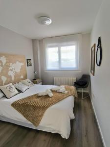 a bedroom with a large bed and a window at El Balcón del Ebro by Alogest- Vistas, piscina y con parking in Zaragoza