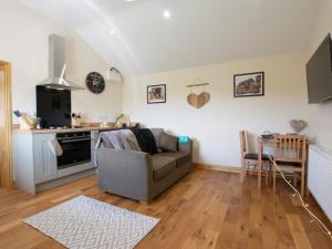 a living room with a couch and a kitchen at 1 Bed in Stapleton 75147 