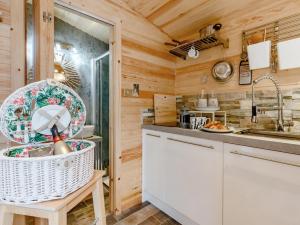 a kitchen with wooden walls and white cabinets at 1 Bed in Pitlochry 75678 in Pitlochry