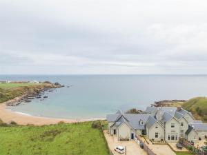 an aerial view of a beach and houses at 4 Bed in Coldingham CA256 in Coldingham