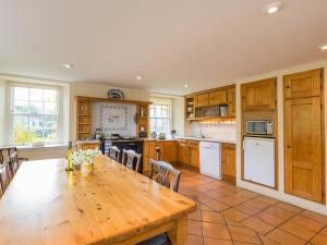 a large kitchen with a wooden table and chairs at 4 Bed in Ancrum CA035 in Saint Boswells