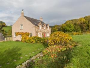 a large house with a garden in front of it at 4 Bed in Ancrum CA035 in Saint Boswells