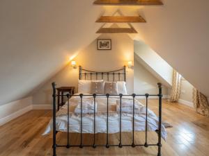 a bedroom with a black bed in a attic at 3 Bed in Balfron Station CA374 in Kepculloch