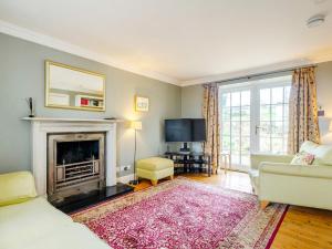 a living room with a fireplace and a tv at 3 Bed in Brodick 77585 in Brodick