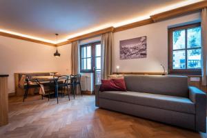 a living room with a couch and a table at Haus Ennsegg by Schladming-Appartements in Haus im Ennstal