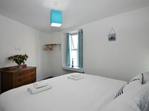 a white bedroom with a white bed and a window at 2 bed in Brixham 75550 in Brixham
