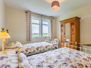 a bedroom with two beds and a window at 2 Bed in Auldearn CA144 in Nairn