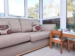 a couch in a living room with a table at 3 Bed in Melrose 76698 in Galashiels